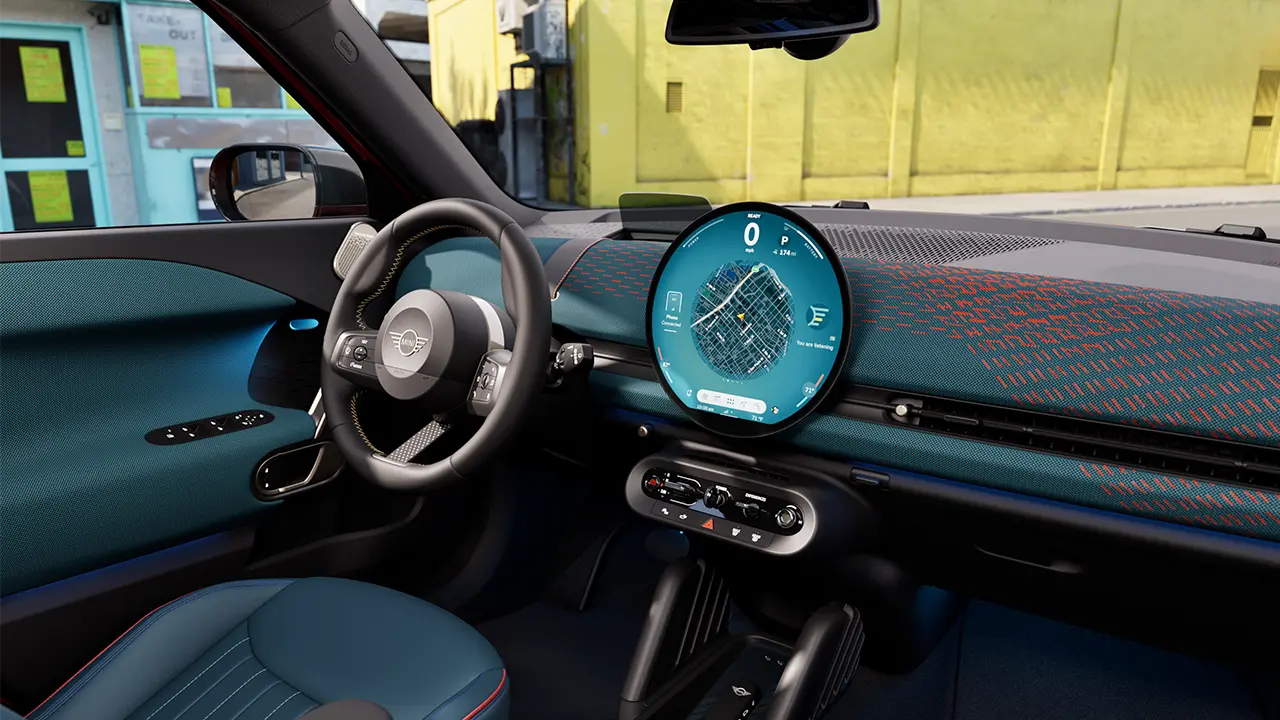 Video showcasing the interior of an all-electric MINI Aceman in detail. The camera pans through the interior and shows the blue upholstery