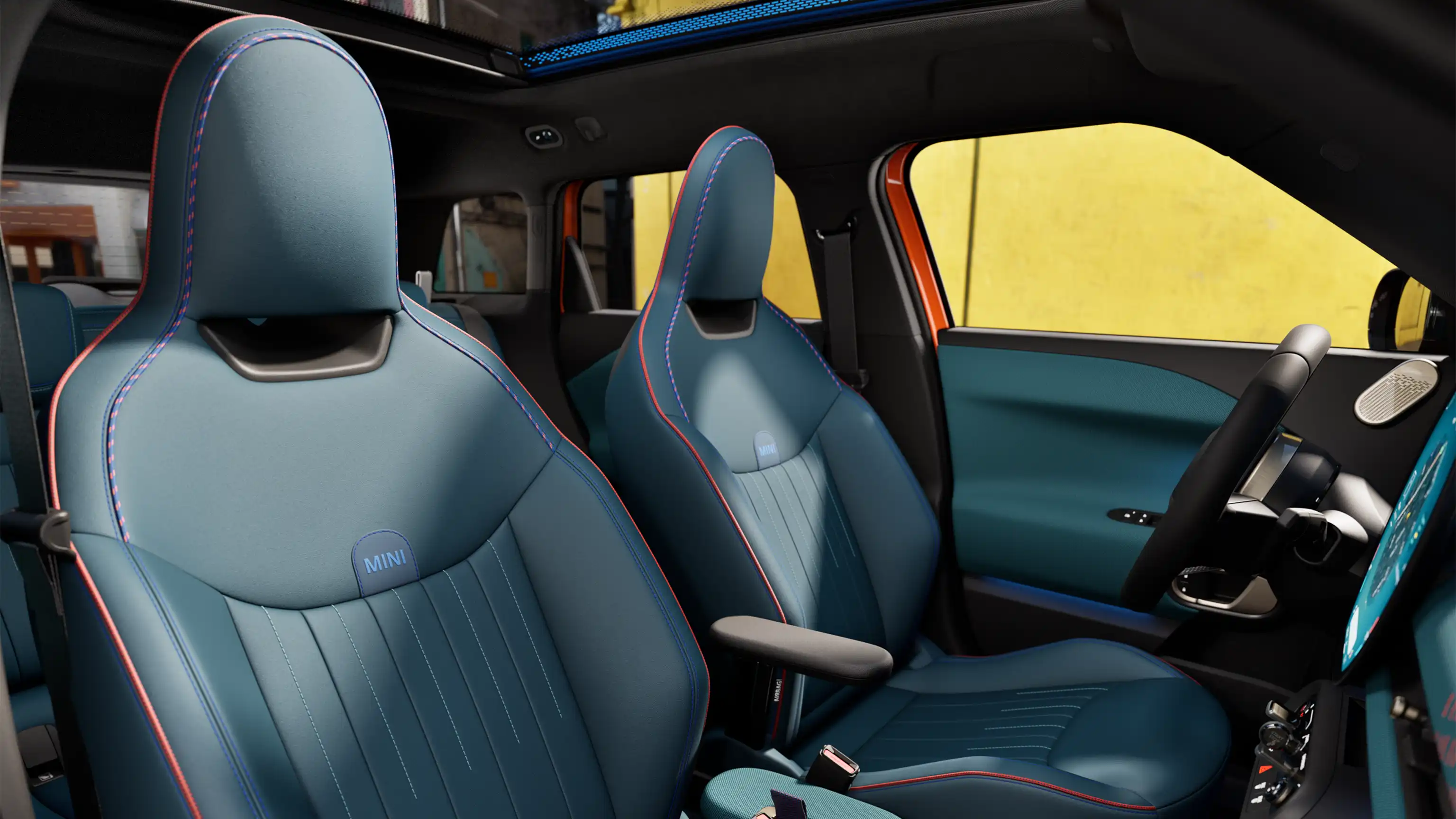 Interior perspective of the all-electric MINI Aceman is showing the dashboard, steering wheel, round display, panorama glassroof  and back of the frontseats