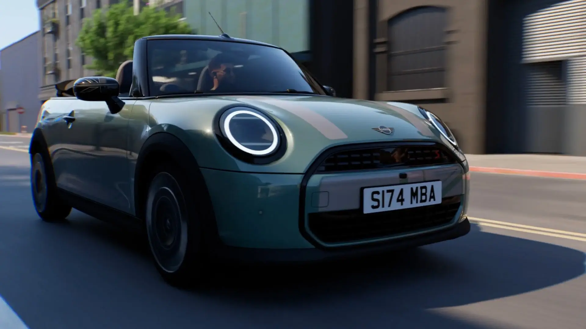 MINIヘリテージ ホワイト・デカールとユニオン・ジャック・ミラー・キャップを装着し、市街地を走行するオーシャン・ウェーブ・グリーンのMINIコンバーチブル。
