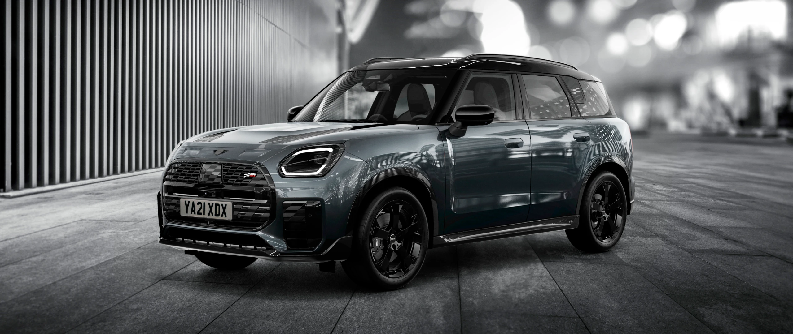 The MINI Countryman Shadow Edition gleams brightly on a nighttime street corner.