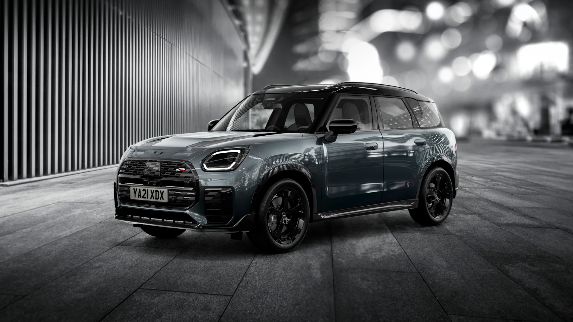 The MINI Countryman Shadow Edition gleams brightly on a nighttime street corner.