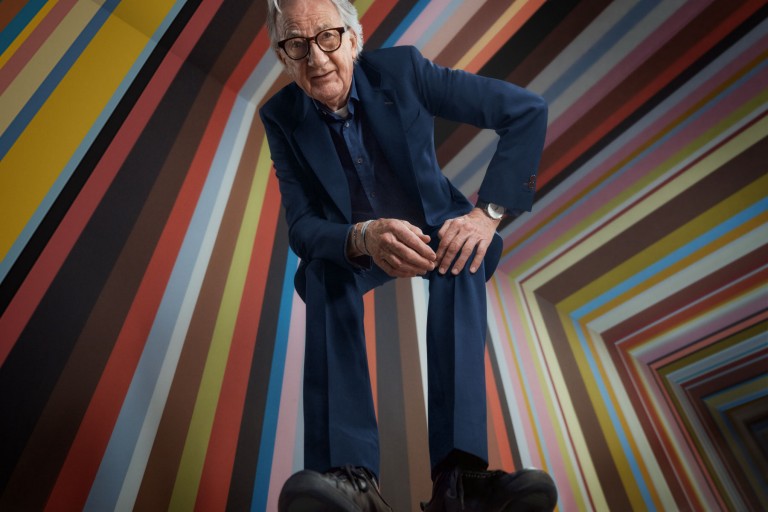 Paul Smith's profile picture posing against a striped background