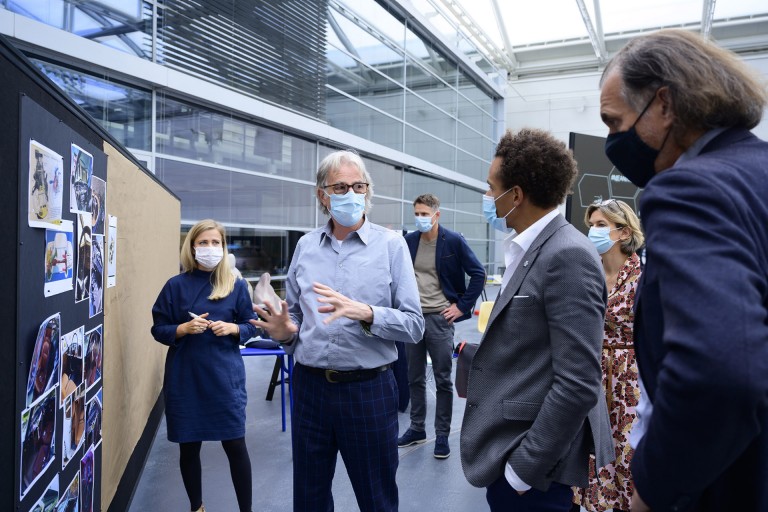 Paul Smith with team members meeting scene